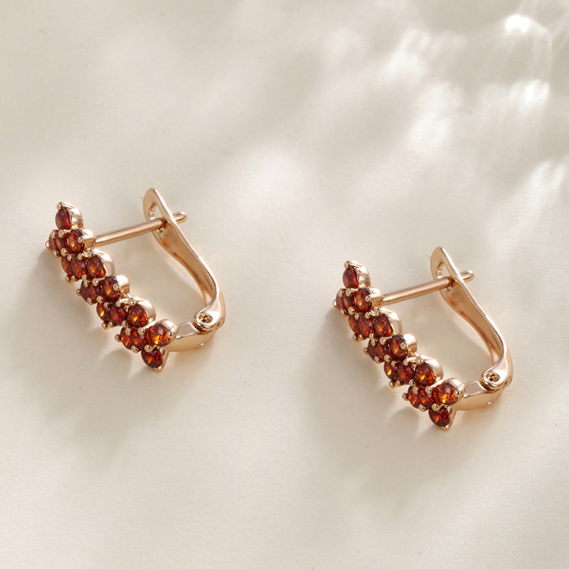 Flower-shaped ear clips with garnet zirconia - 18K gold-plated copper alloy (height 1.5 cm)