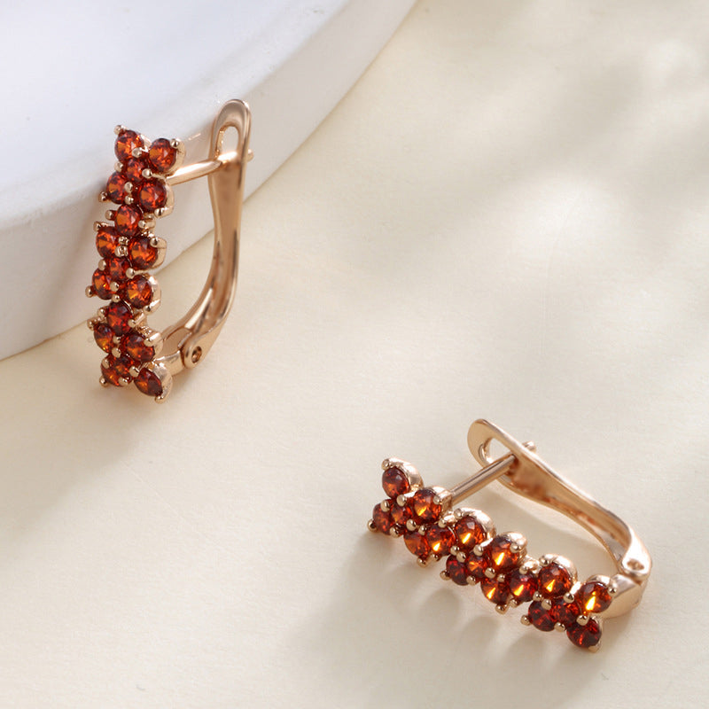 Flower-shaped ear clips with garnet zirconia - 18K gold-plated copper alloy (height 1.5 cm)