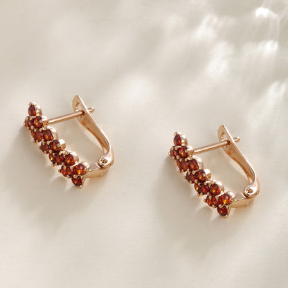 Flower-shaped ear clips with garnet zirconia - 18K gold-plated copper alloy (height 1.5 cm)